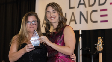 Vanessa Keesee receives the Sharon Cox award from Kathryn Thalken, Executive Director for the Ladder Alliance.