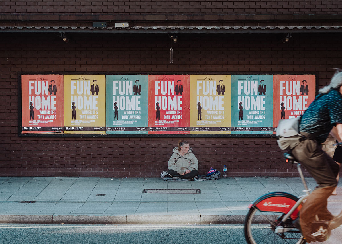 Woman sits in front of posters