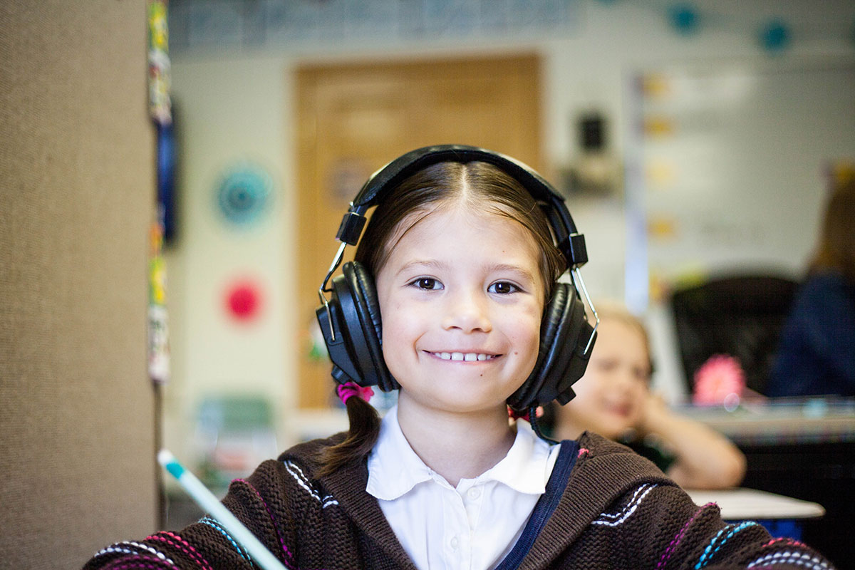 A child with headphones at school.