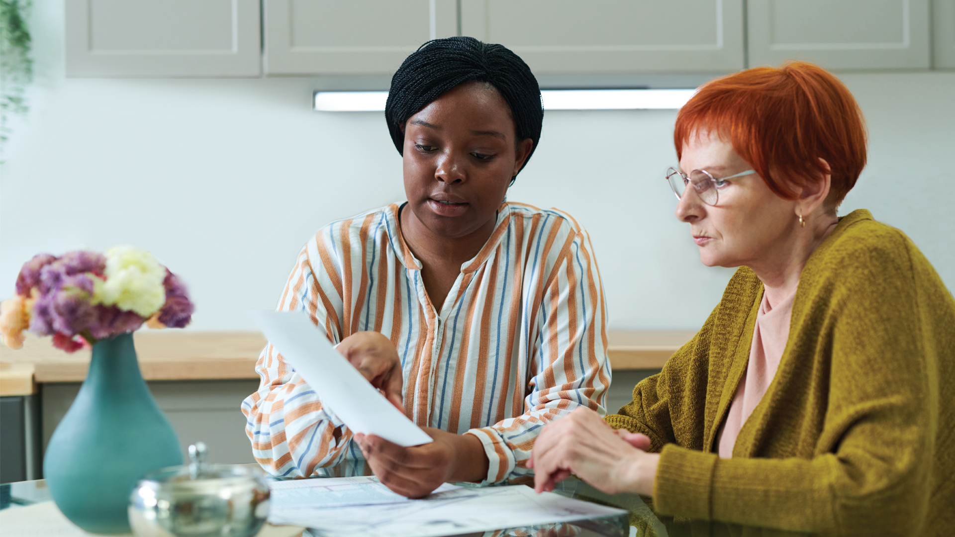 two women looking at paper