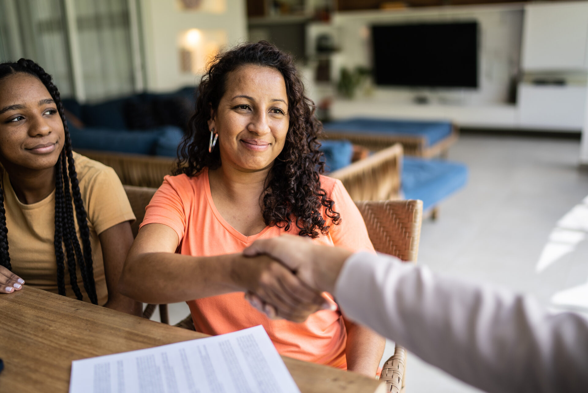 woman shaking a man's hand