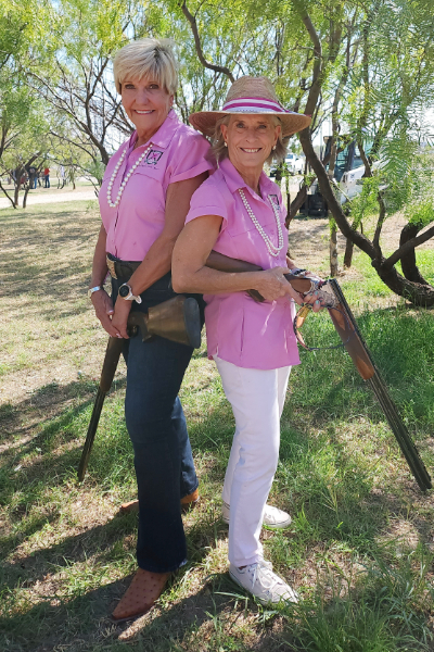 Betsy Price and Linda Halbouty dressed in pink shirts, wearing pearl necklaces. 