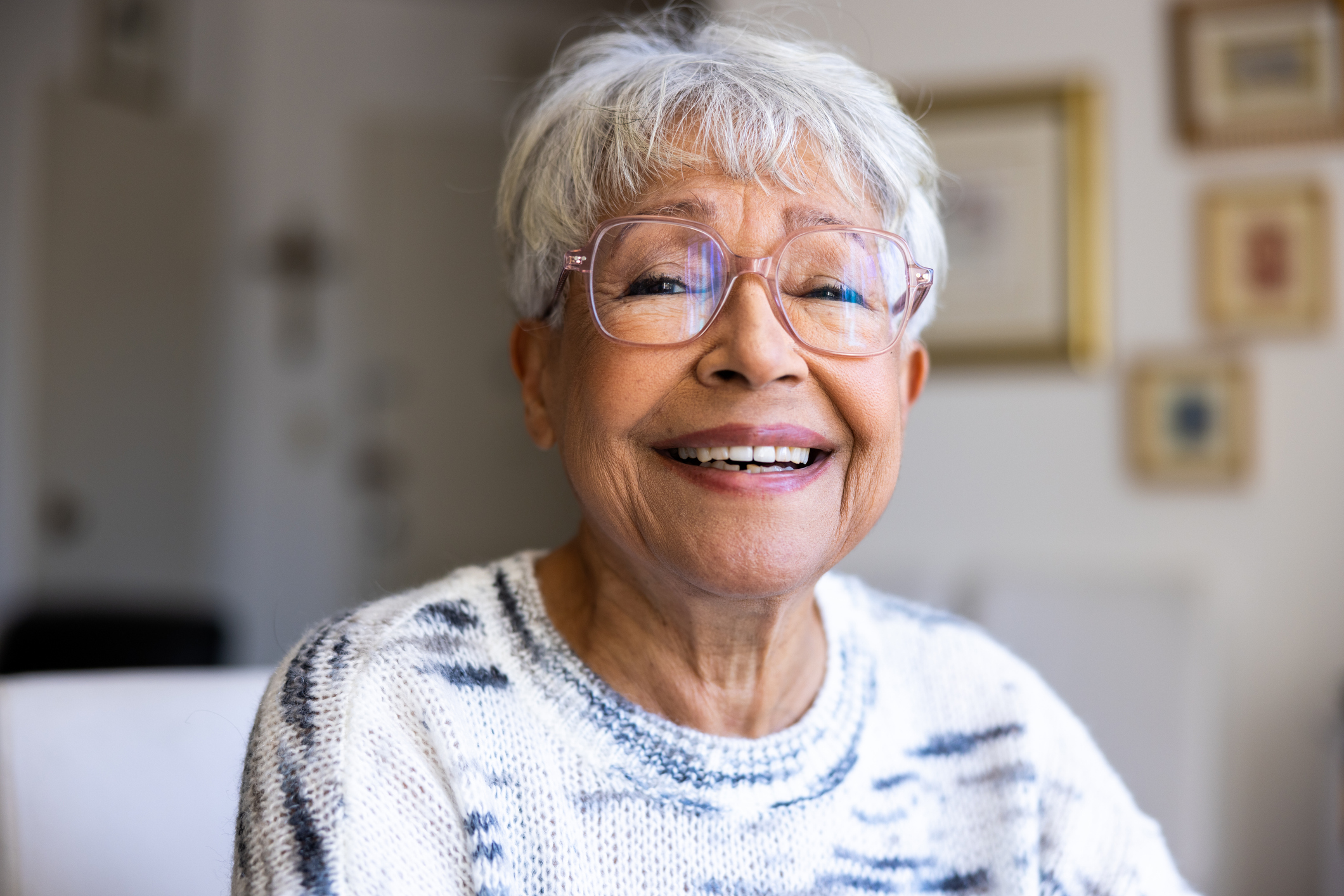 Older woman smiling at home.