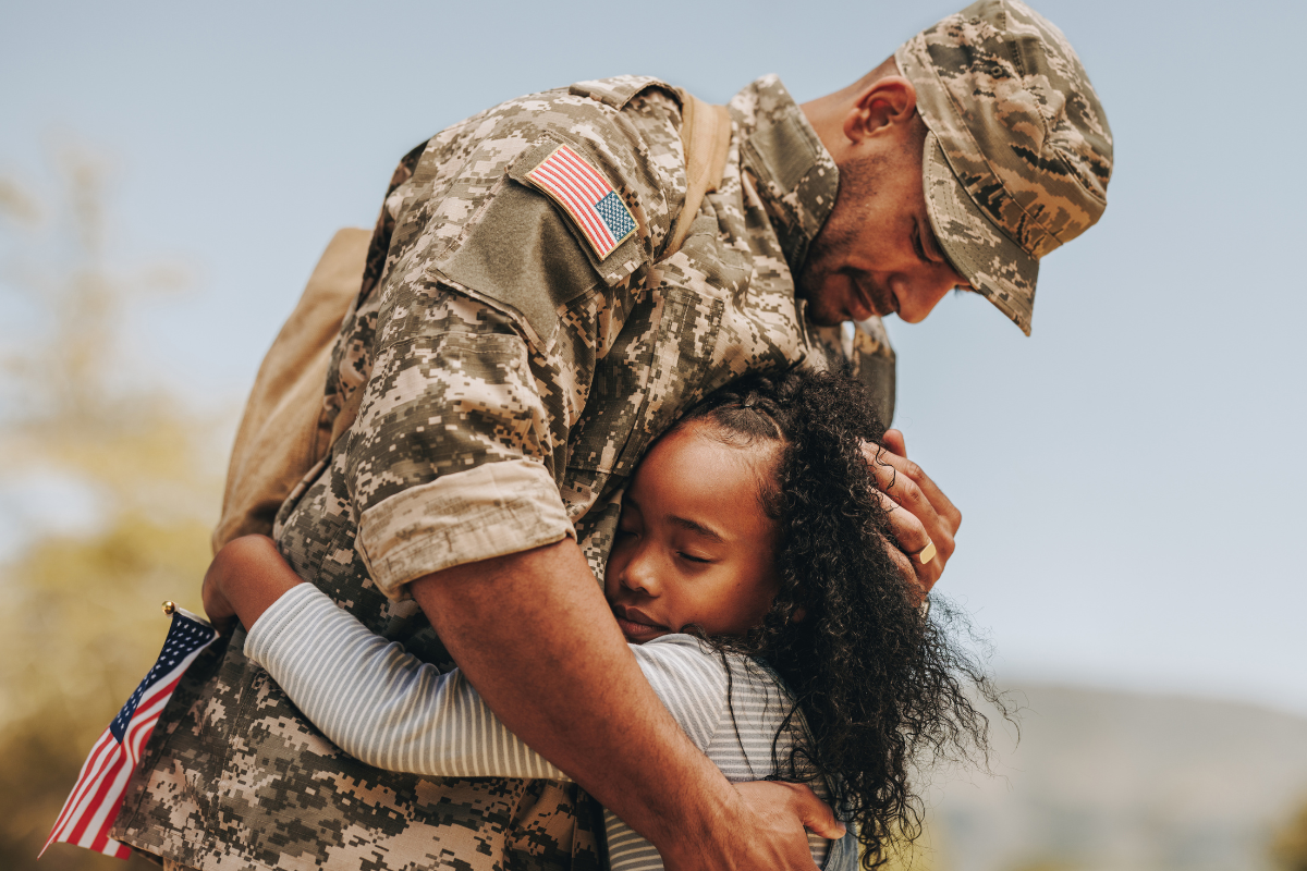 Soldier hugging child
