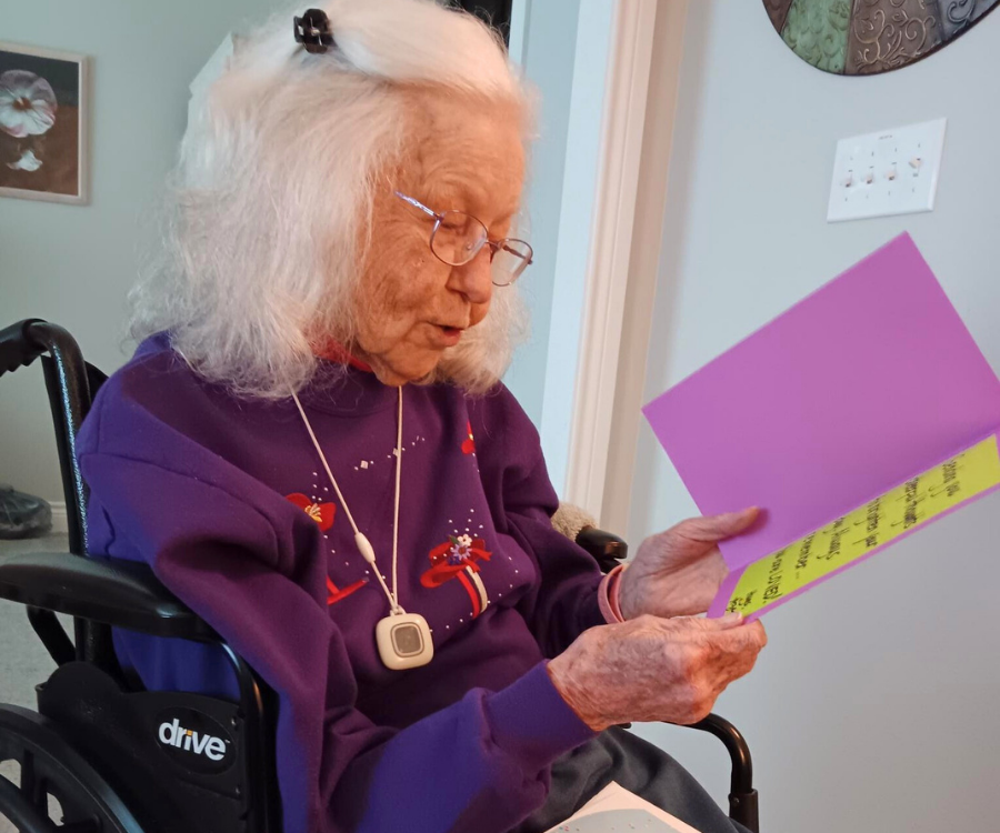 Person in wheelchair reading a greeting card. 