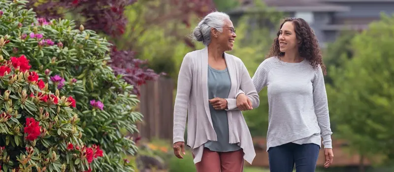 Two people walking a garden