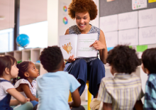 Teacher reading a book to students