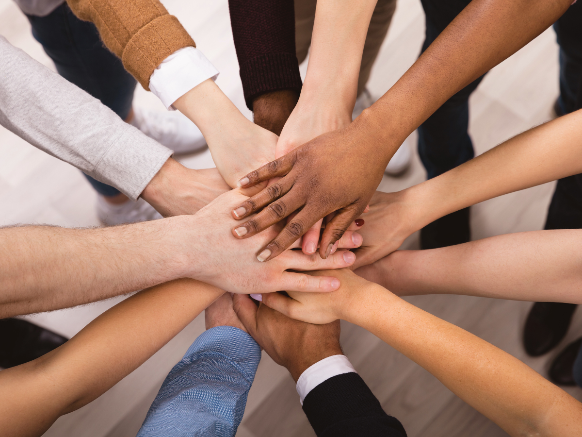 Hands in center of group