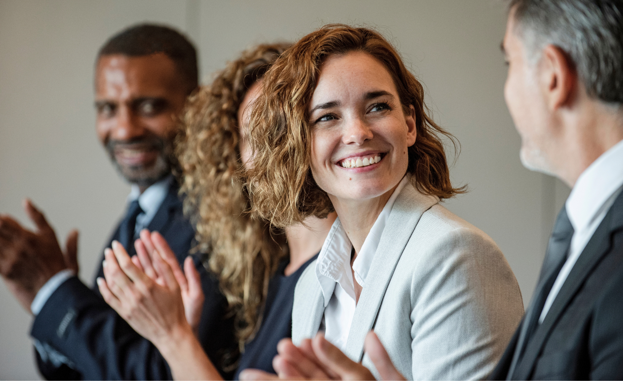 People clapping in a board meeting