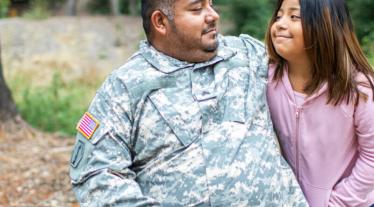 man in wheelchair next to girl