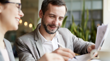 Man signing tax documents.