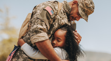 Soldier hugging child