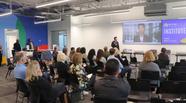 Image of a speaker giving a presentation at the AI Day 