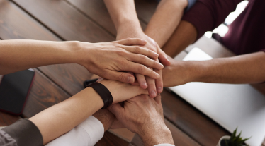 Hands in center of group